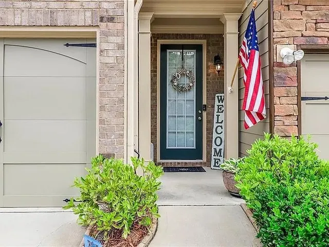 a front view of a house with plants