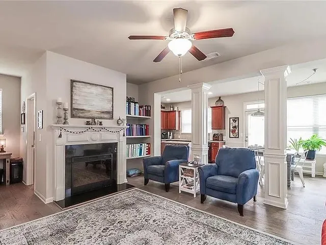 a living room with furniture a window and a fireplace