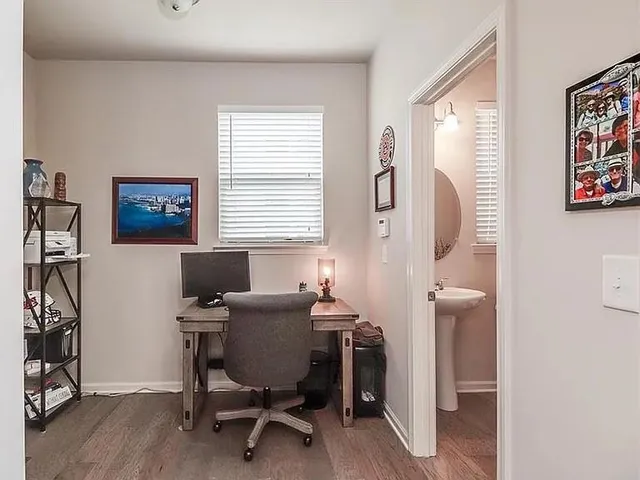 a view of a workspace with furniture and a window