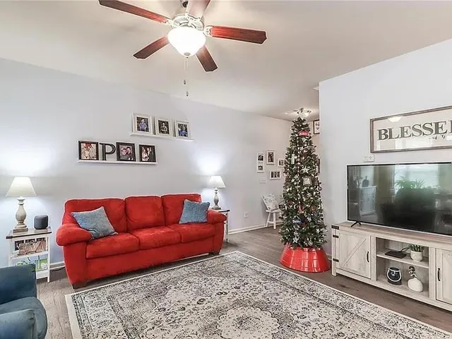 a living room with furniture and a flat screen tv