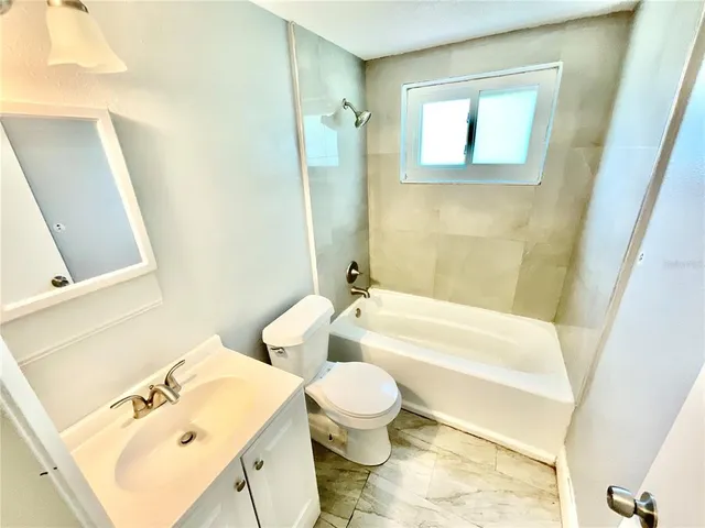 a bathroom with a sink a toilet and a bathtub