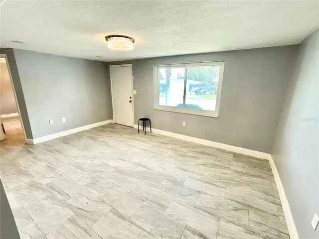 a view of an empty room with a window