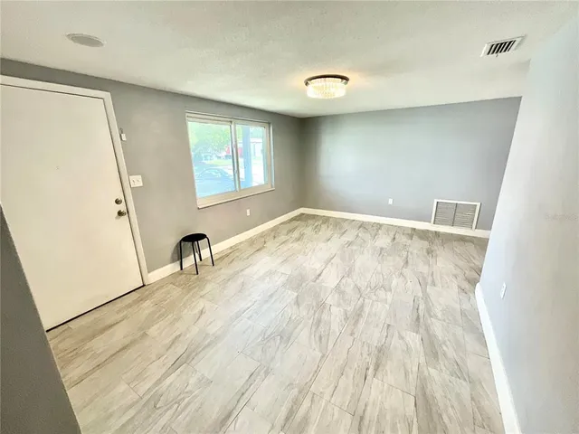 a view of a room with wooden floor and windows