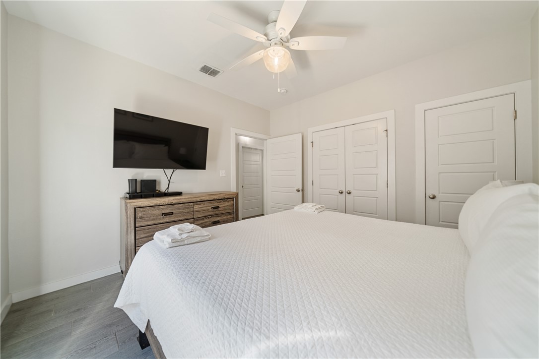 15113 Kokomo Drive Corpus Christi, TX 78418 - Photo 16 of 25 a bedroom with a bed and a flat screen tv