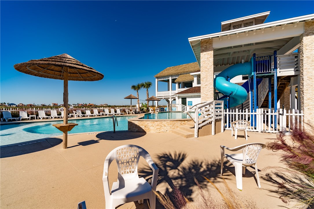15113 Kokomo Drive Corpus Christi, TX 78418 - Photo 23 of 25 a view of a swimming pool with a table and chairs