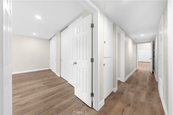a large white kitchen with granite countertop a large window and a sink