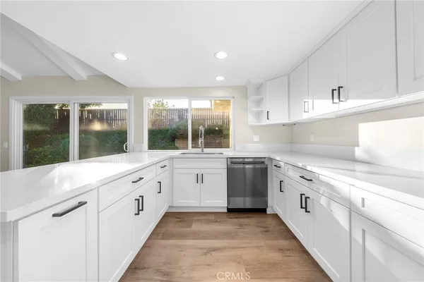 a kitchen with stainless steel appliances granite countertop a stove a sink dishwasher and a refrigerator