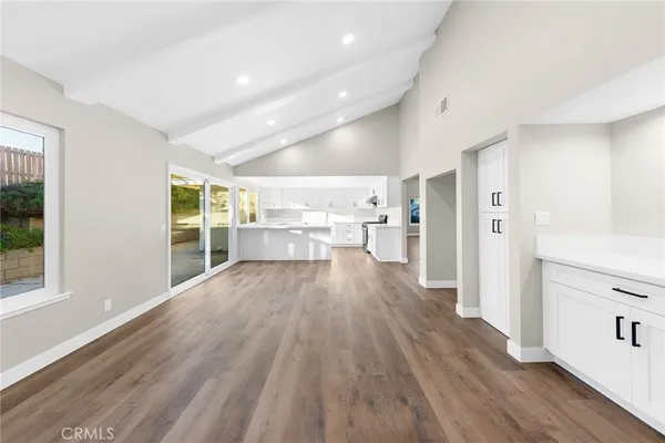 a view of large kitchen with wooden floor