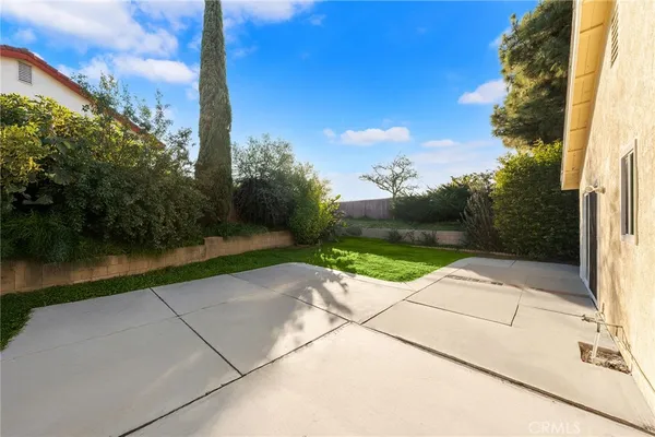 a view of a house with a yard and sitting area