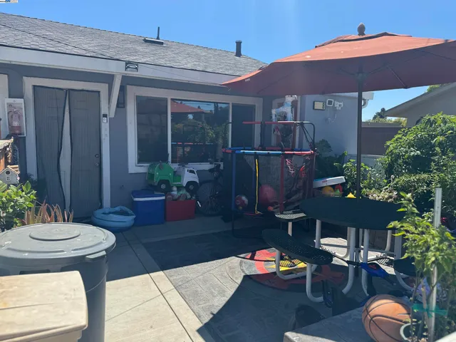 a backyard of a house with table and chairs
