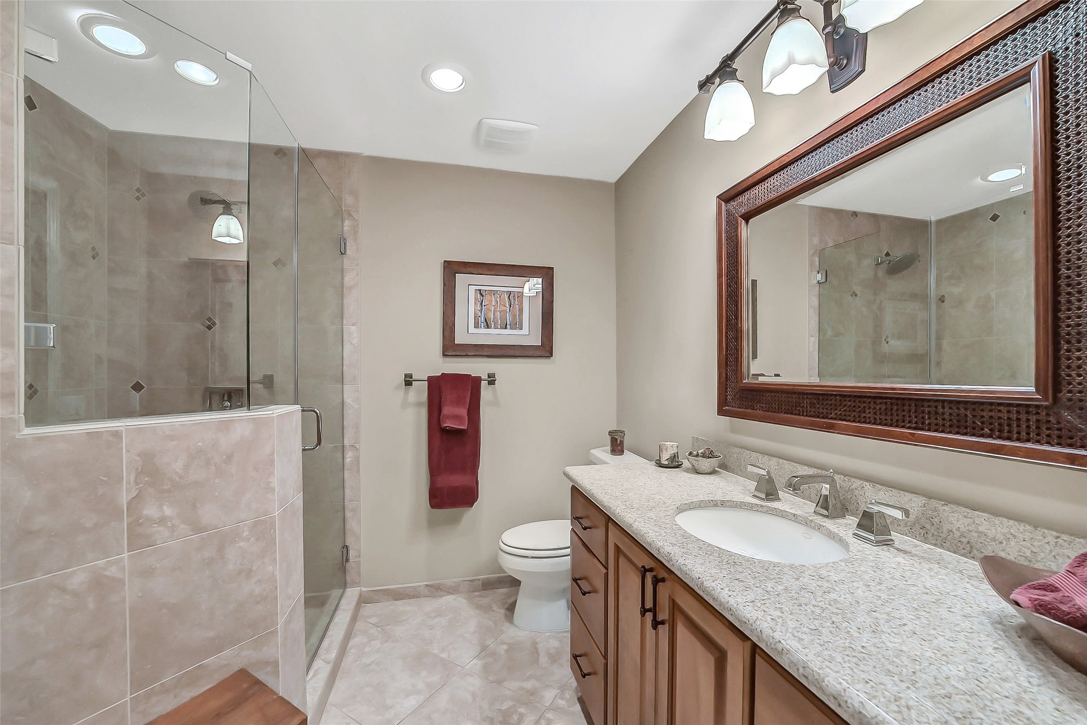 5626 Hummingbird Street Houston, TX 77096 - Photo 23 of 34 The en-suite bath for the guest room was also previously renovated and shows very nicely. It includes revised cabinetry with single sink and plenty of counter space. There is also the very large, tile and glass shower. All are still in pristine condition.