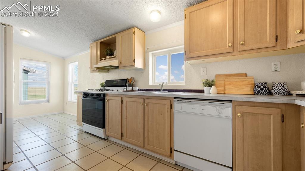 36925 Shear Road Yoder, CO 80864 - Photo 12 of 34 a kitchen with granite countertop a sink and a stove top oven