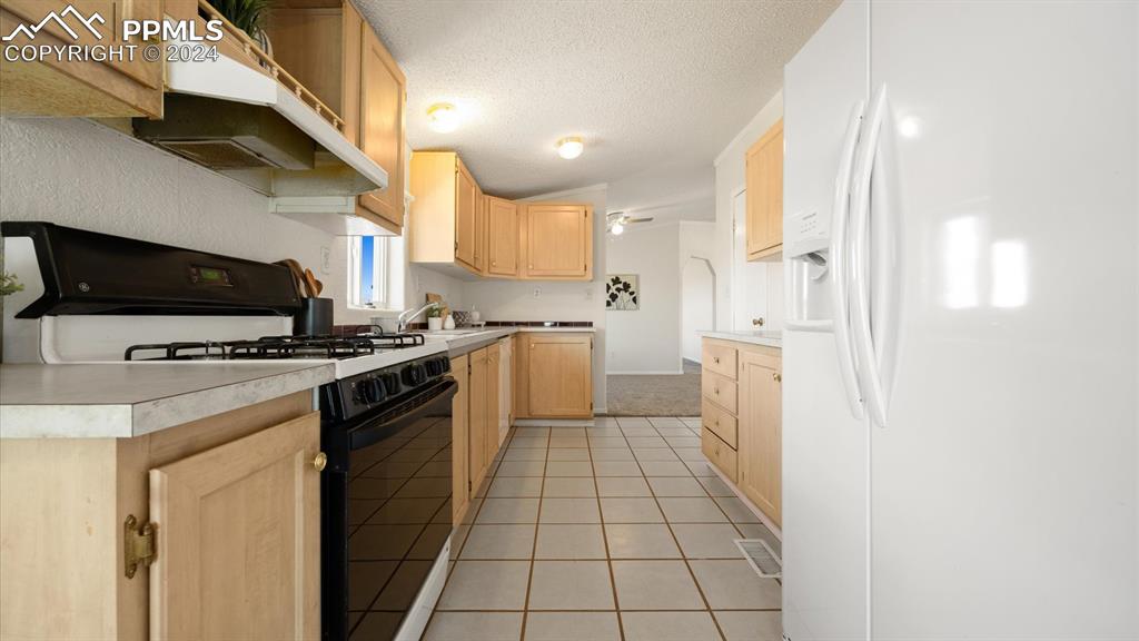 36925 Shear Road Yoder, CO 80864 - Photo 13 of 34 a kitchen with stainless steel appliances a stove a sink and a refrigerator