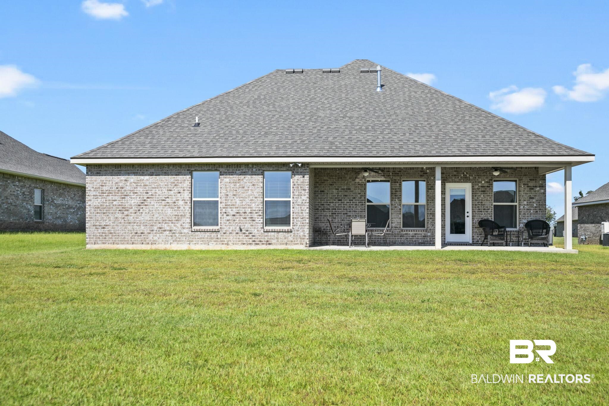 10140 Chipper Lane Foley, AL 36535 - Photo 43 of 72 Back of property featuring a patio and a lawn