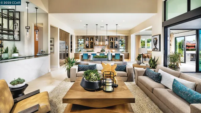 a kitchen with stainless steel appliances kitchen island granite countertop a table chairs in it and wooden floors