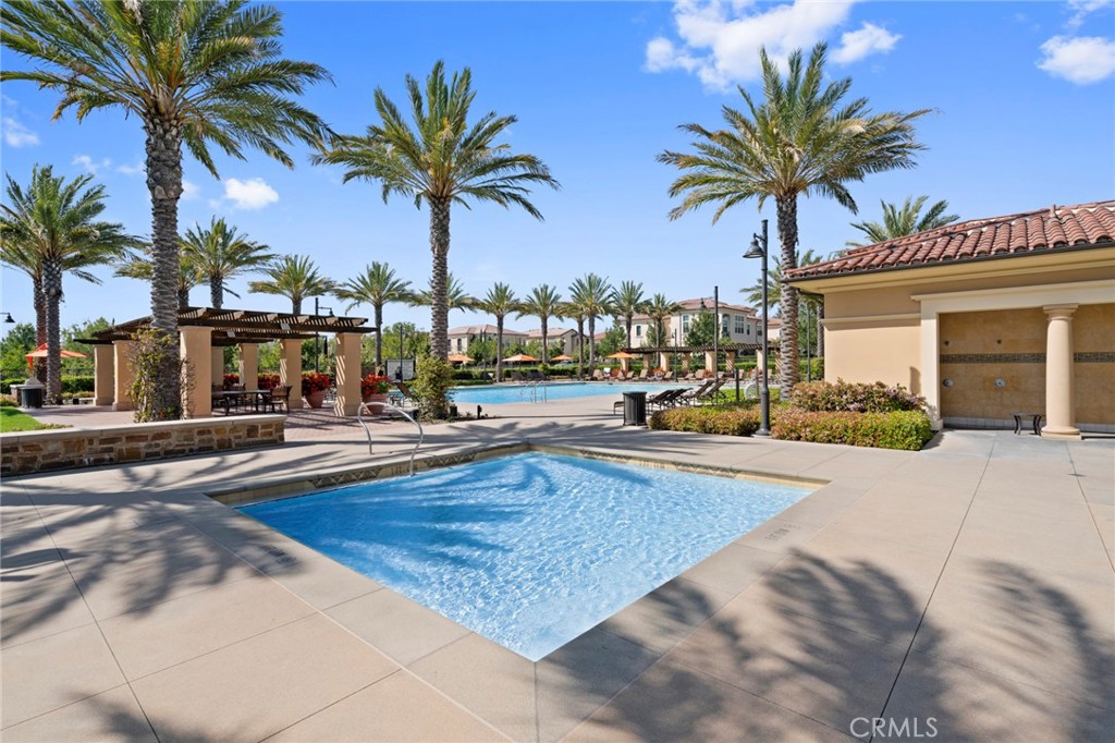 57 Bandana Irvine, CA 92602 - Photo 32 of 32 a view of a swimming pool with a chair and palm trees