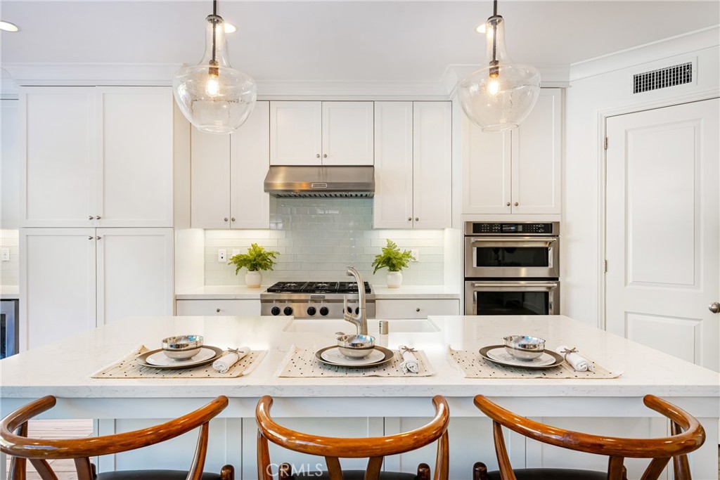 57 Bandana Irvine, CA 92602 - Photo 6 of 32 a kitchen with stainless steel appliances a table and chairs in it