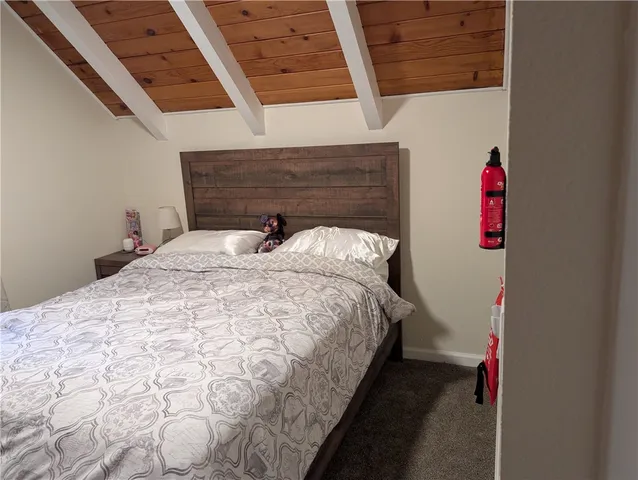 a bed sitting in a bedroom next to a white wall