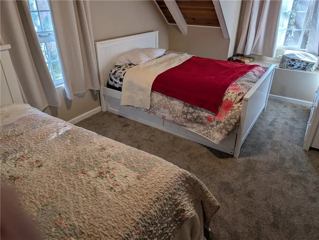 a bedroom with a bed and a mirror