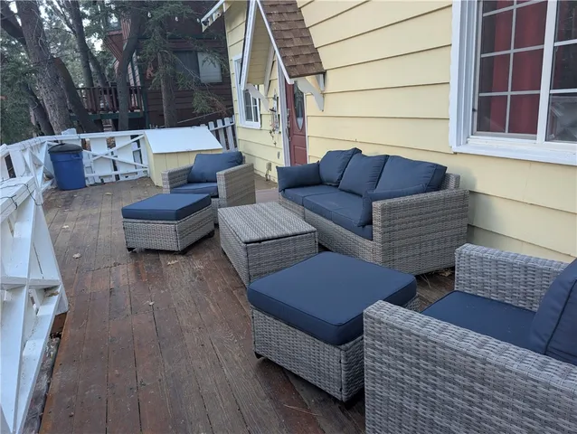 a view of outdoor living space with furniture and wooden floor
