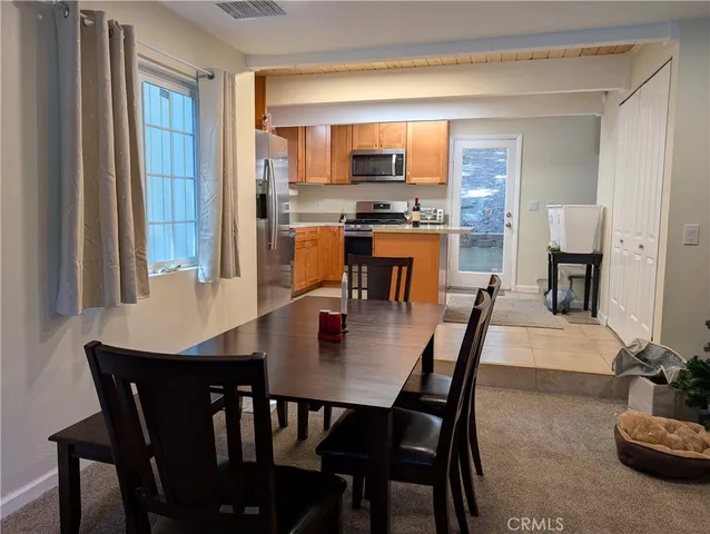 a dining room with furniture and window