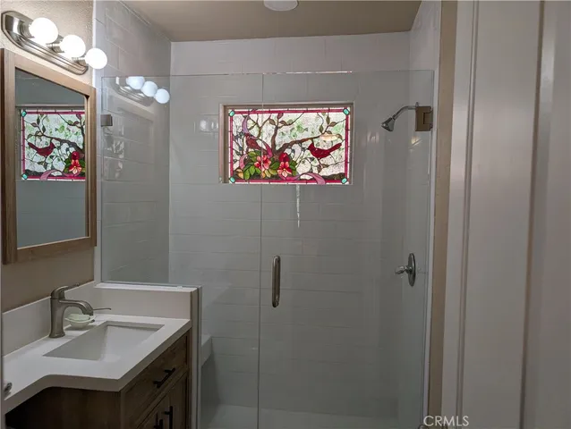 a bathroom with a sink mirror and vanity