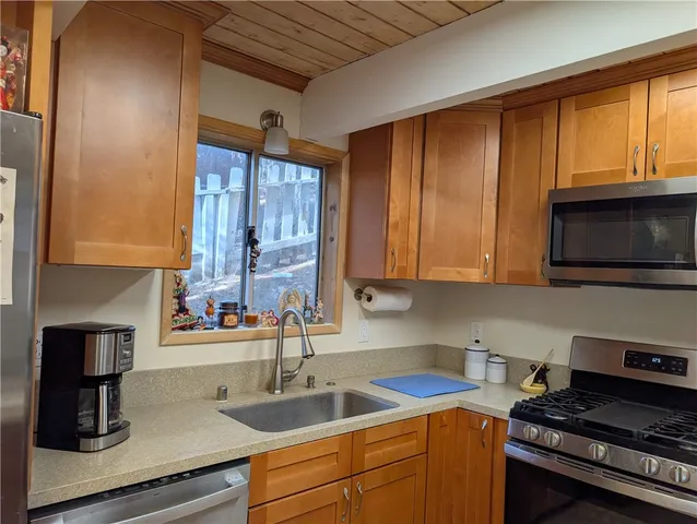 a kitchen with a sink and a stove top oven