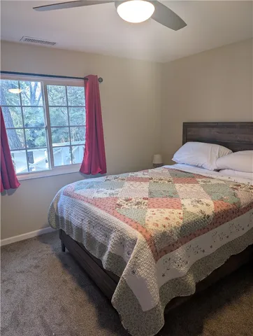 a bed sitting in a bedroom next to a window