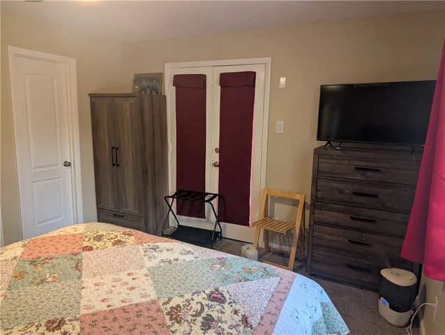 a bedroom with a bed and a television