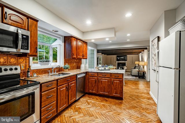 a kitchen with stainless steel appliances granite countertop a stove sink and microwave