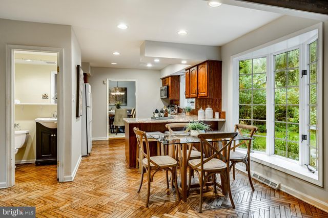 a bathroom with a sink and mirror with toilet