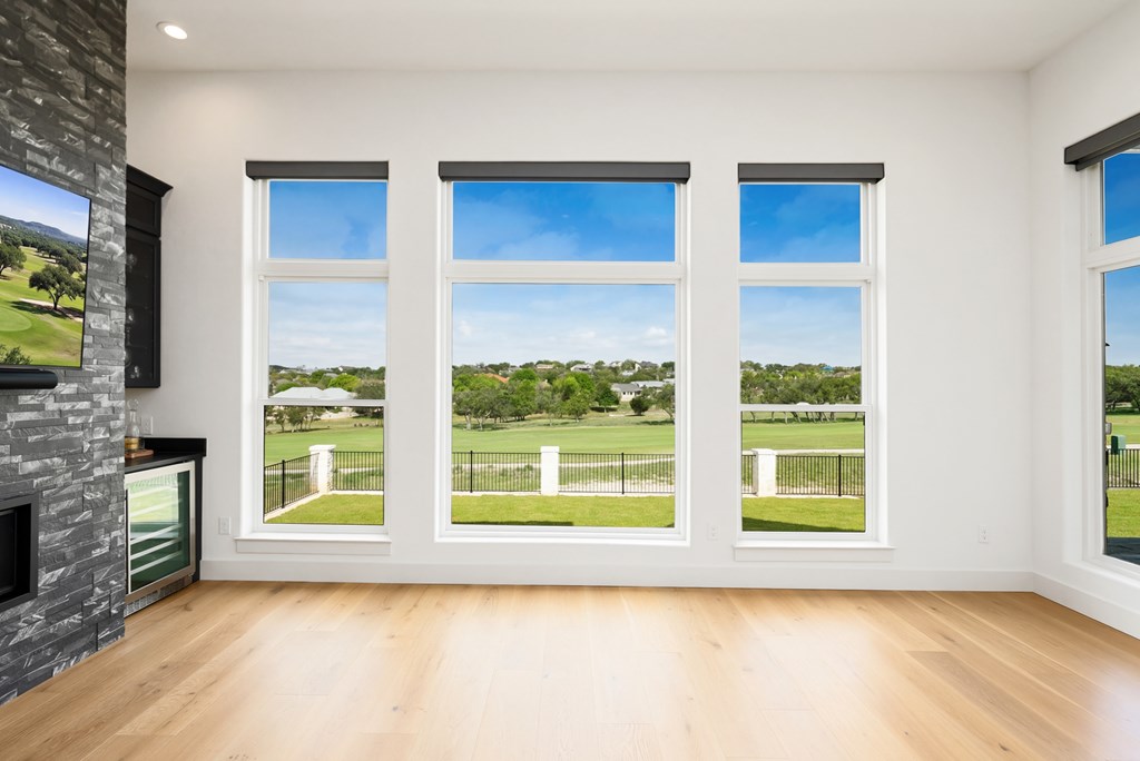 1029 Club House Road Kerrville, TX 78028 - Photo 19 of 62 a view of an empty room with window and fire place