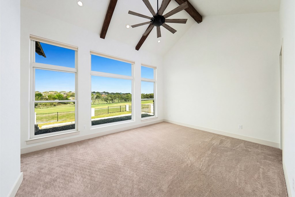 1029 Club House Road Kerrville, TX 78028 - Photo 22 of 62 an empty room with windows and ceiling fan