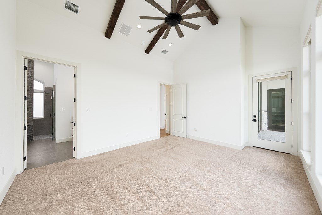 1029 Club House Road Kerrville, TX 78028 - Photo 24 of 62 an empty room with chandelier fan and windows