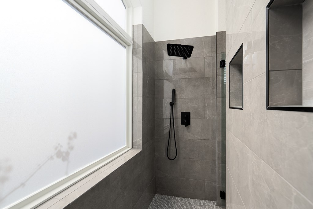 1029 Club House Road Kerrville, TX 78028 - Photo 27 of 62 a bathroom with a glass shower door