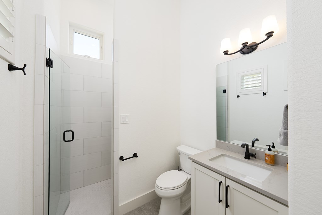 1029 Club House Road Kerrville, TX 78028 - Photo 34 of 62 a bathroom with a sink toilet and vanity