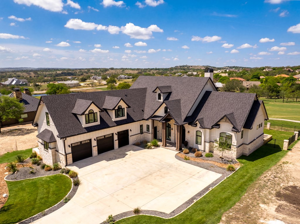 1029 Club House Road Kerrville, TX 78028 - Photo 59 of 62 an aerial view of a house with a garden and lake view