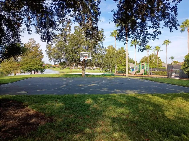 a view of yard with green space and trees