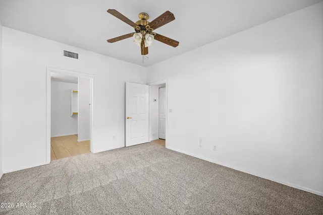 an empty room with a empty space and a ceiling fan