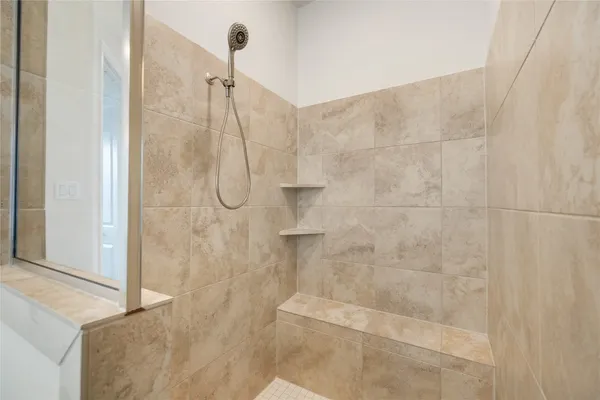 a bathroom with a tub sink and mirror