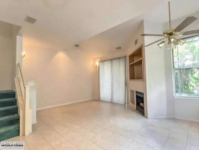 a view of a livingroom with a fireplace and window