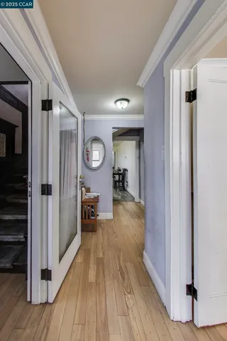 a view of a hallway view with wooden floor and workspace
