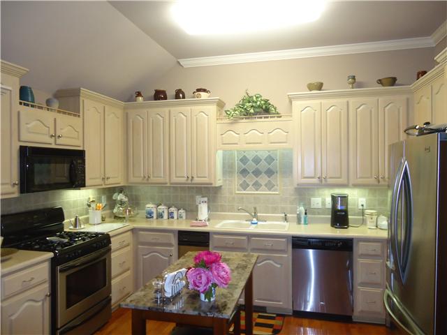 30724 Mill Race Road Ardmore, TN 38449 - Photo 7 of 20 Kitchen - Features include under cabinet lighting, tile back splash, wood flooring, crown molding and an abundance of cabinets and counter space. Dishwasher & refrigerator are new in 2013.