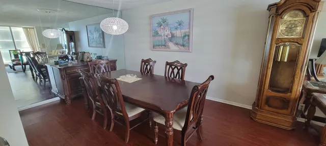 a view of a a dining room with furniture window and wooden floor