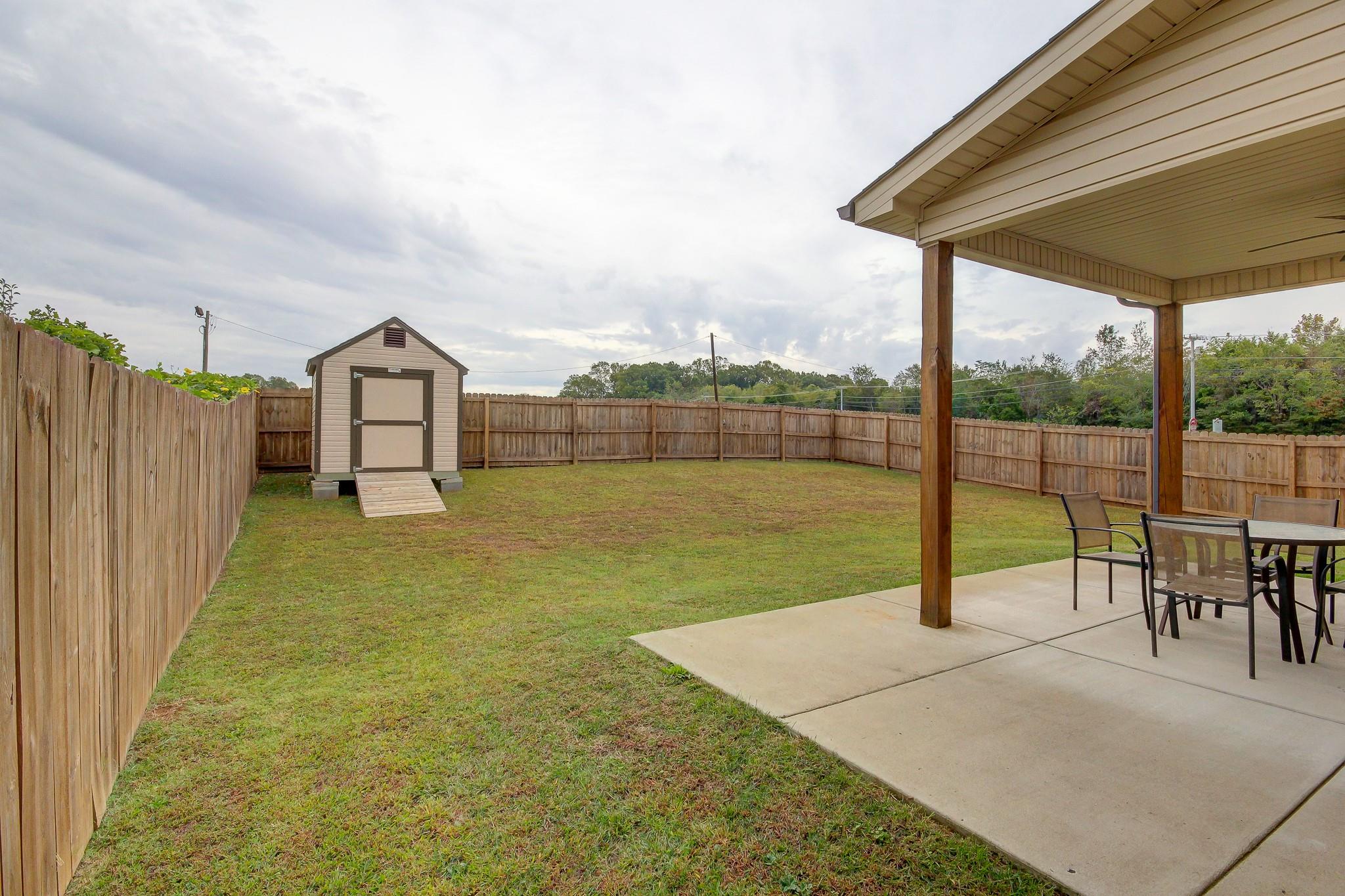 1012 Barnhill Road Clarksville, TN 37043 - Photo 16 of 18 a view of a patio with a table chairs and a backyard