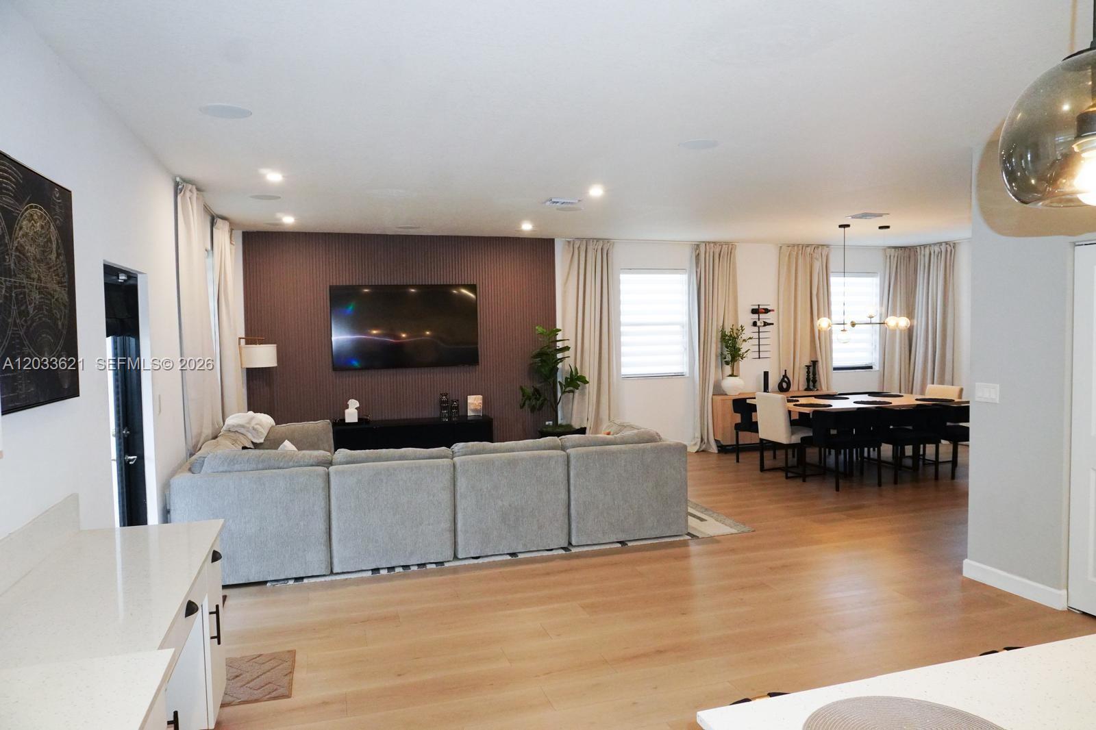 11942 Southwest 243rd Street Homestead, FL 33032 - Photo 5 of 50 a living room with furniture and a flat screen tv