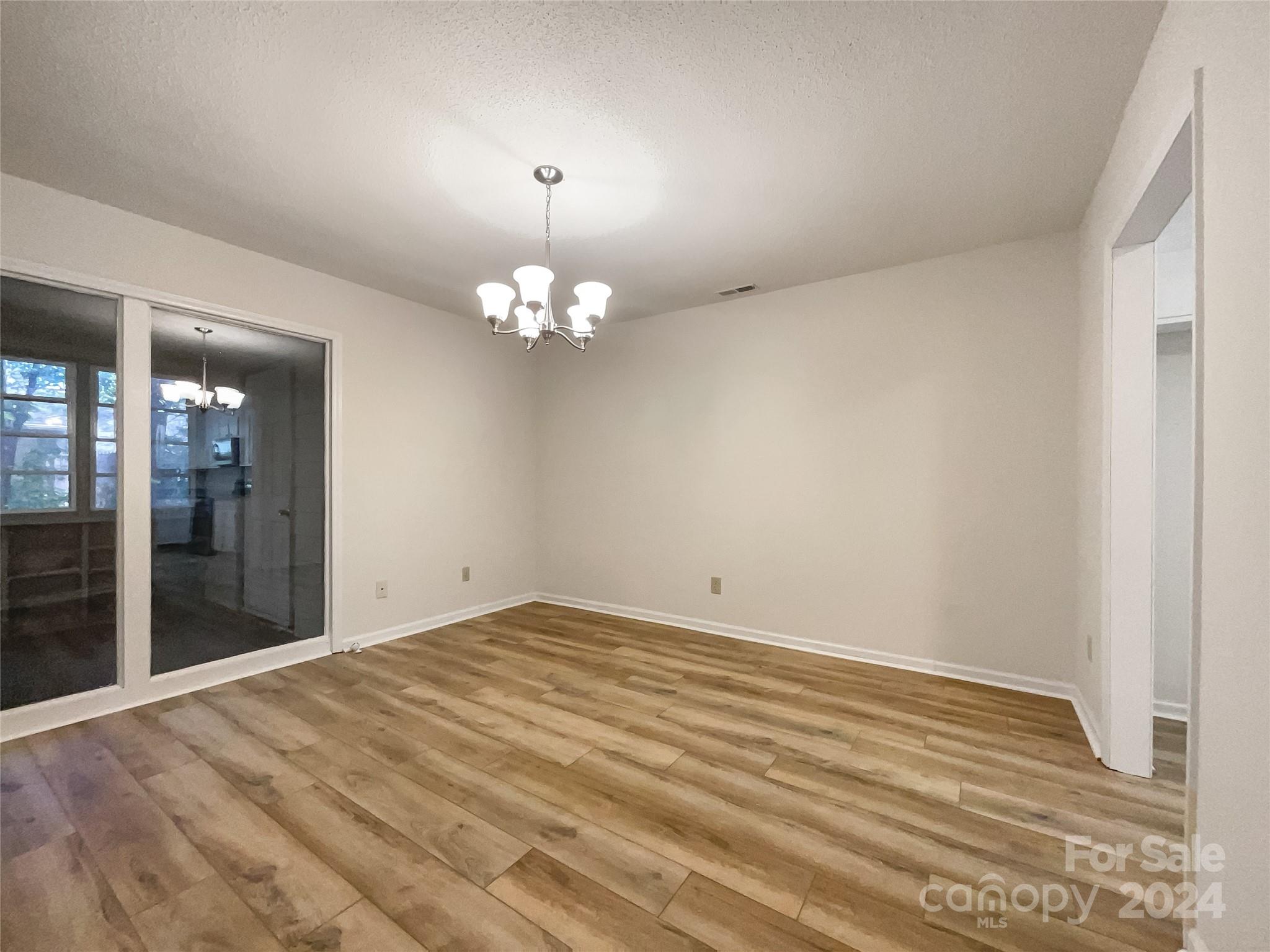 123 David Court Fort Mill, SC 29715 - Photo 12 of 18 a view of an empty room with wooden floor