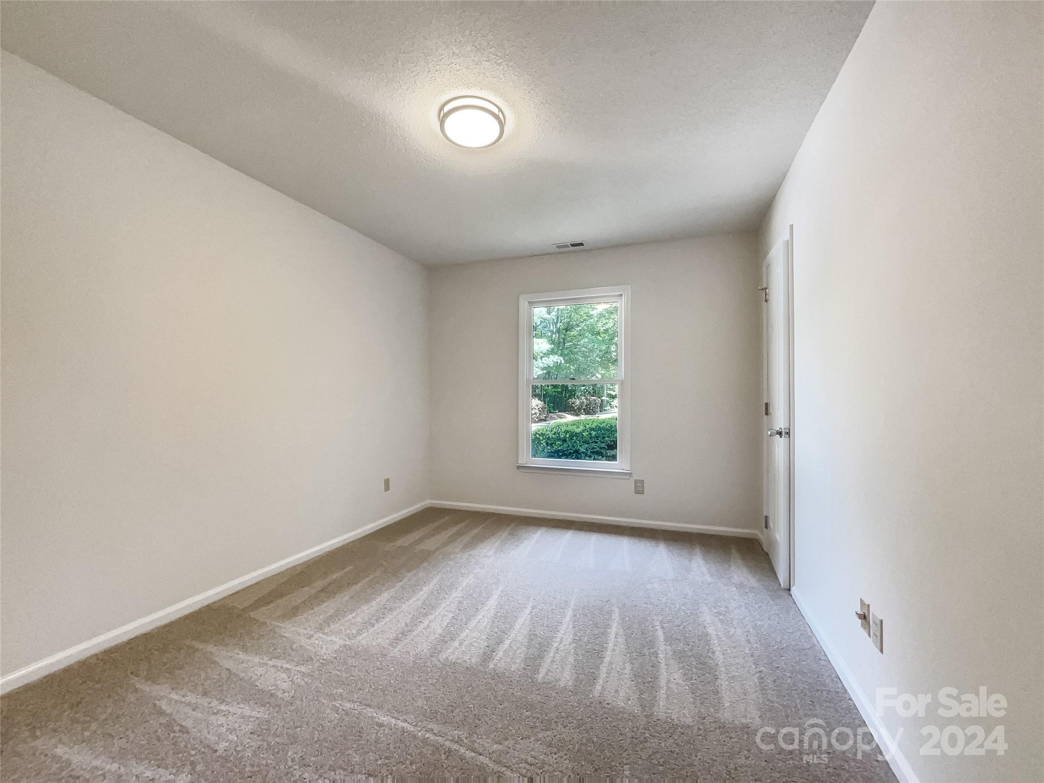 123 David Court Fort Mill, SC 29715 - Photo 14 of 18 an empty room with wooden floor and windows