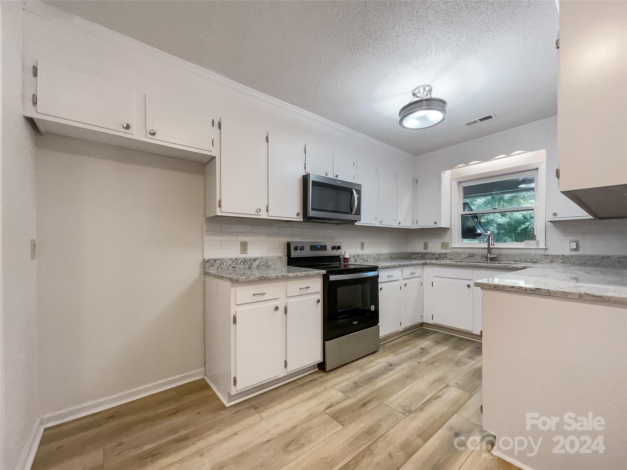 123 David Court Fort Mill, SC 29715 - Photo 6 of 18 a kitchen with granite countertop cabinets stainless steel appliances a sink and a window