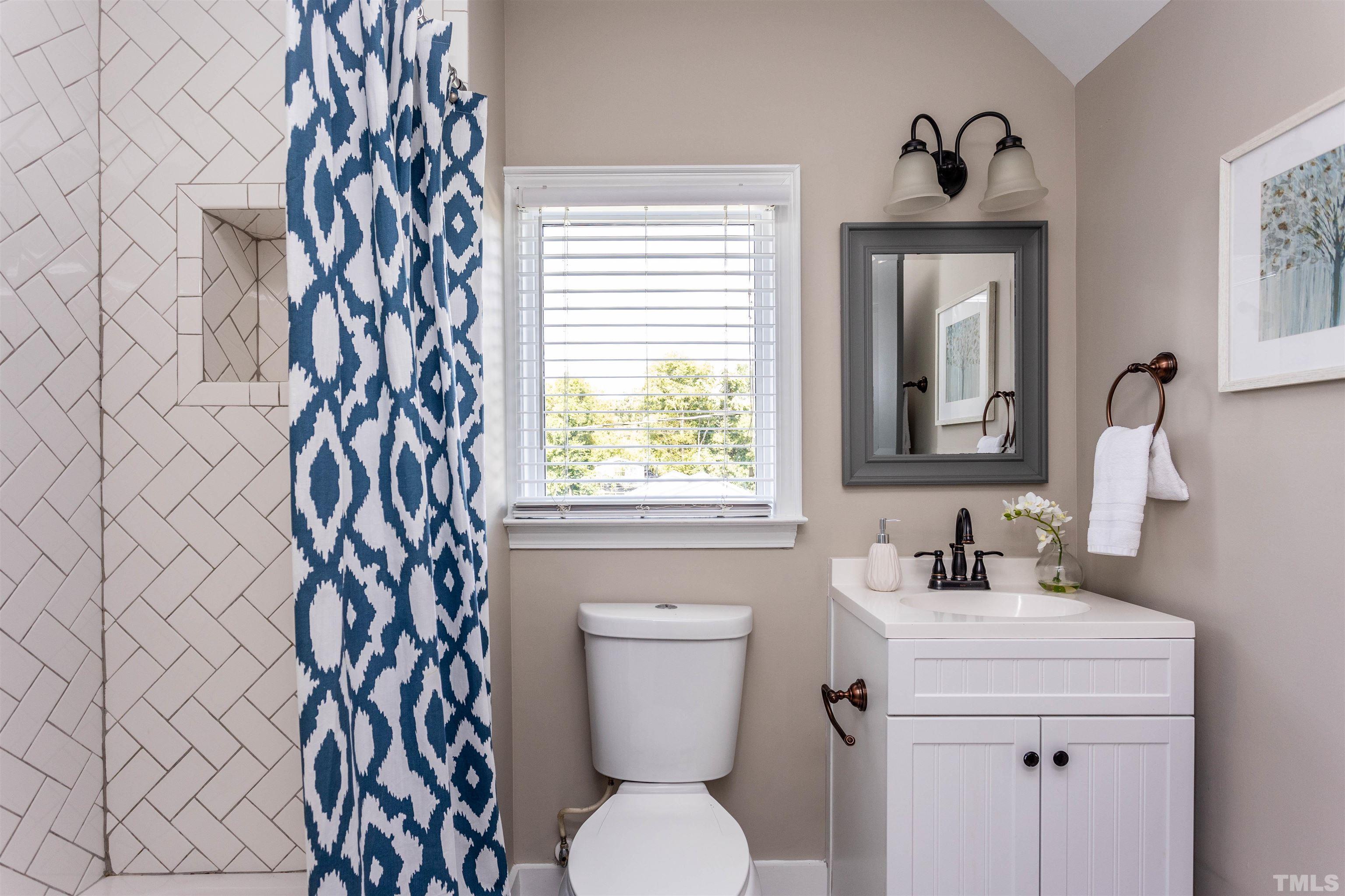 312 Freeman Street Raleigh, NC 27601 - Photo 21 of 30 a bathroom with a toilet sink and mirror